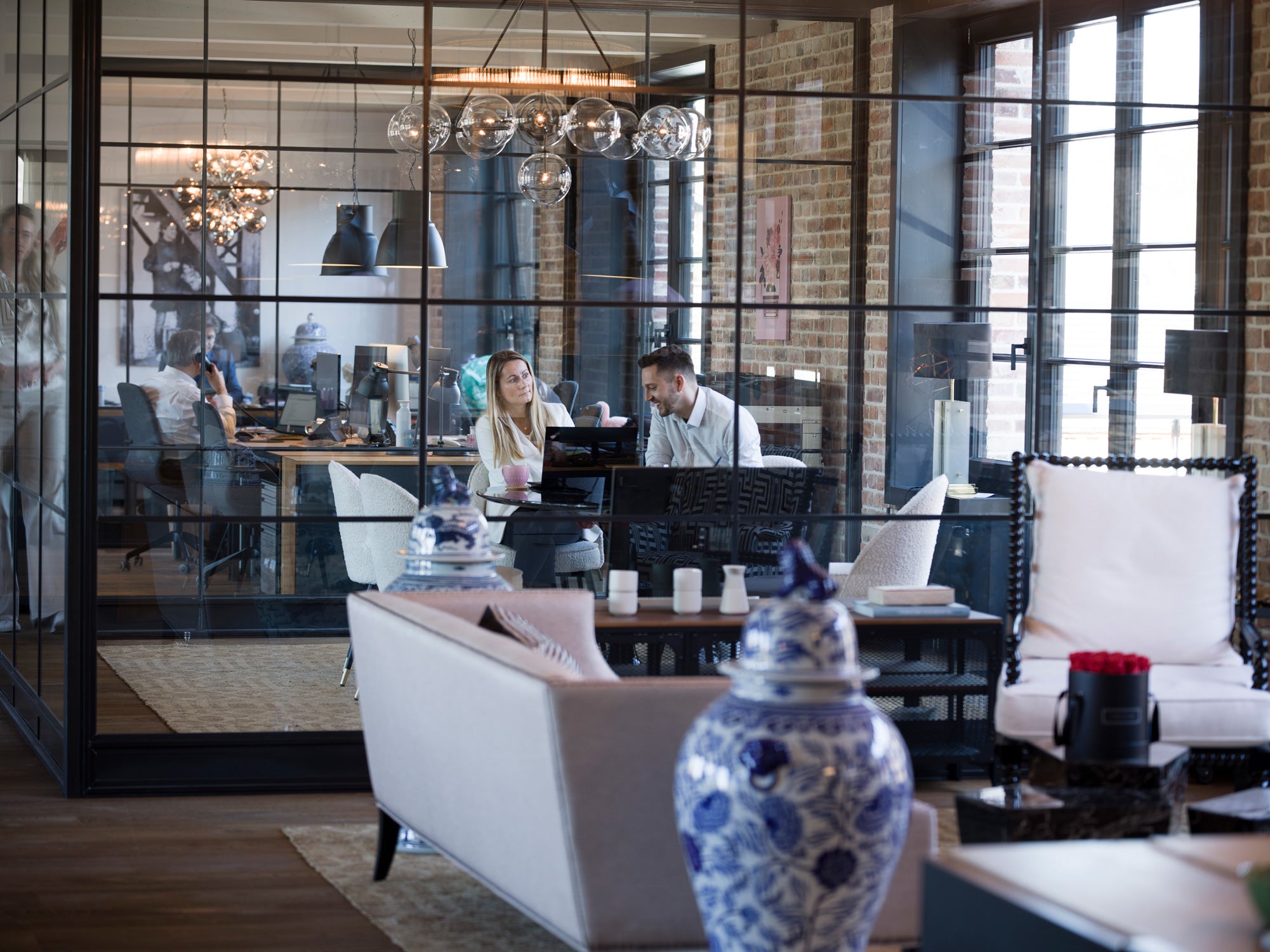 Moderne Büroumgebung mit großen Fenstern, Menschen arbeiten und kommunizieren, blau-weißes Dekor.